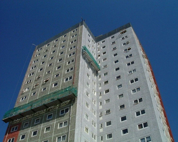 Suspended access cradles operating on a high-rise residential block