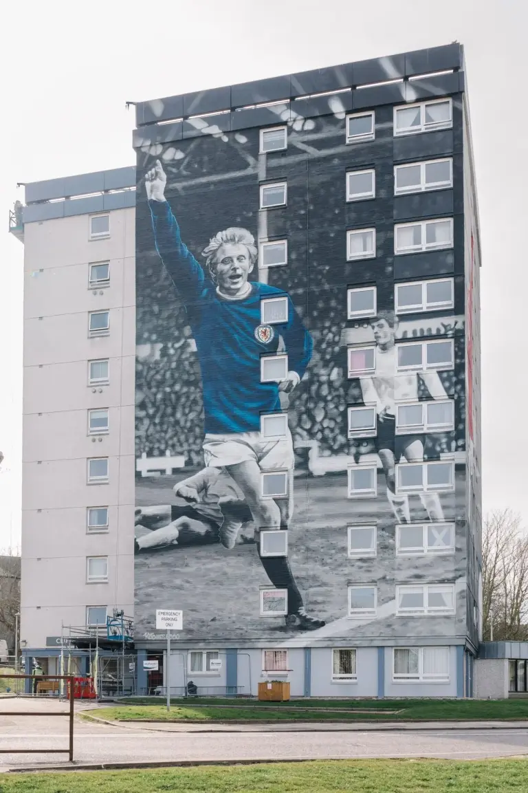 Denis Law football mural spanning a residential façade